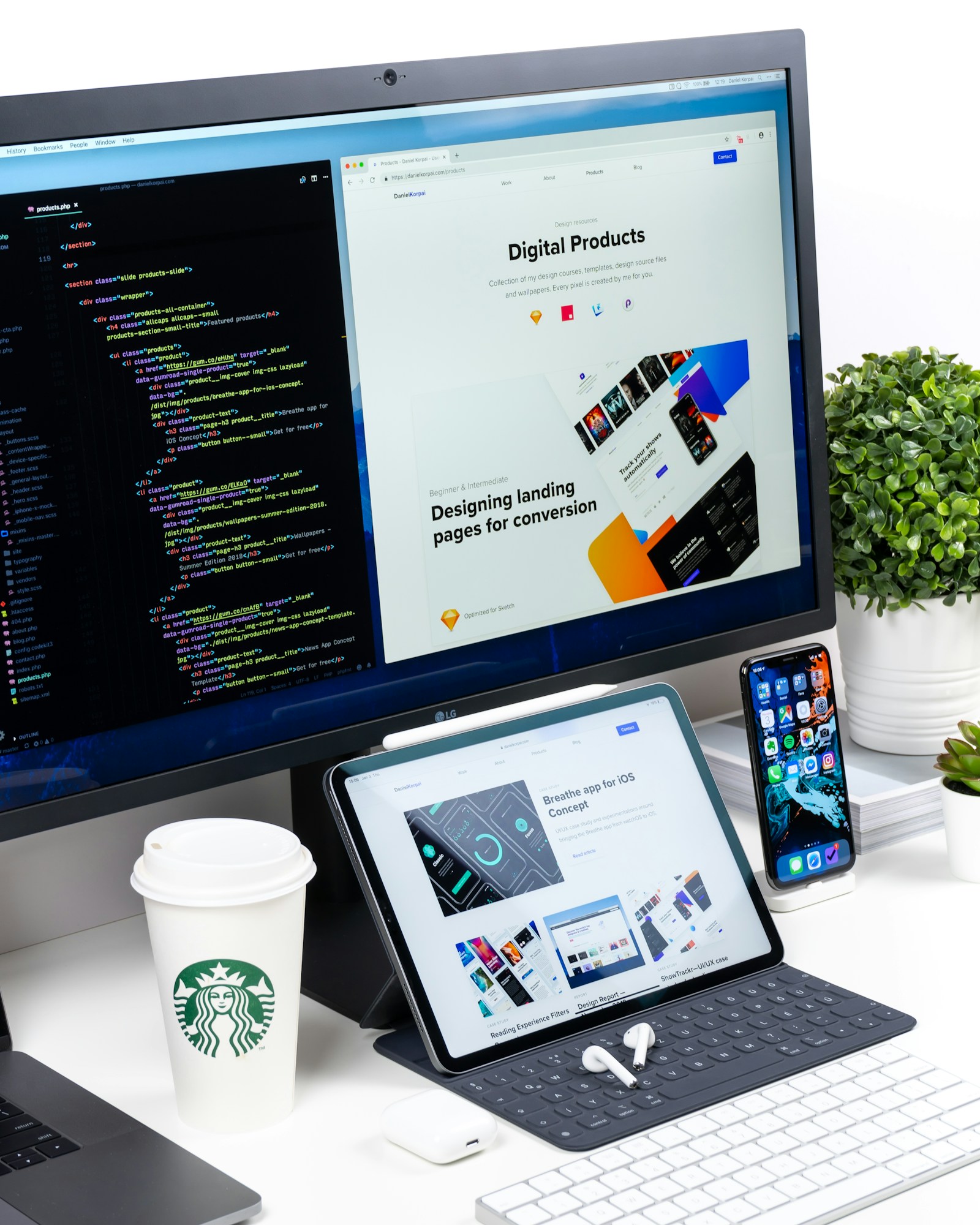 Desktop monitor displaying code next to a tablet showing a website layout