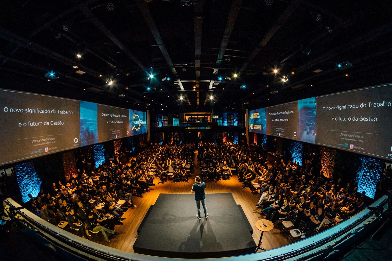 Speaker on stage addressing a seated conference audience